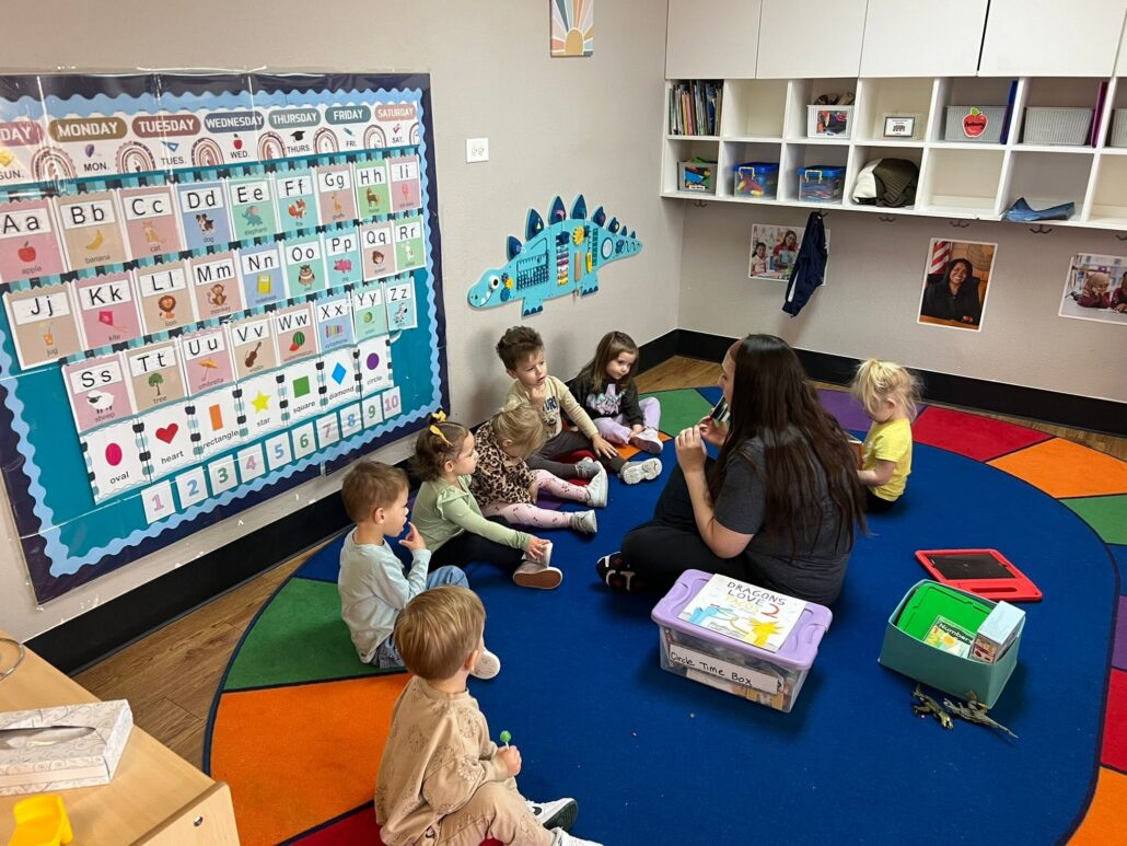 children listening to teacher read at preschool and daycare at cadence academy preschool in the colony texas