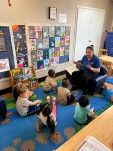 children listening to teacher read at preschool and daycare at cadence academy preschool in the colony texas