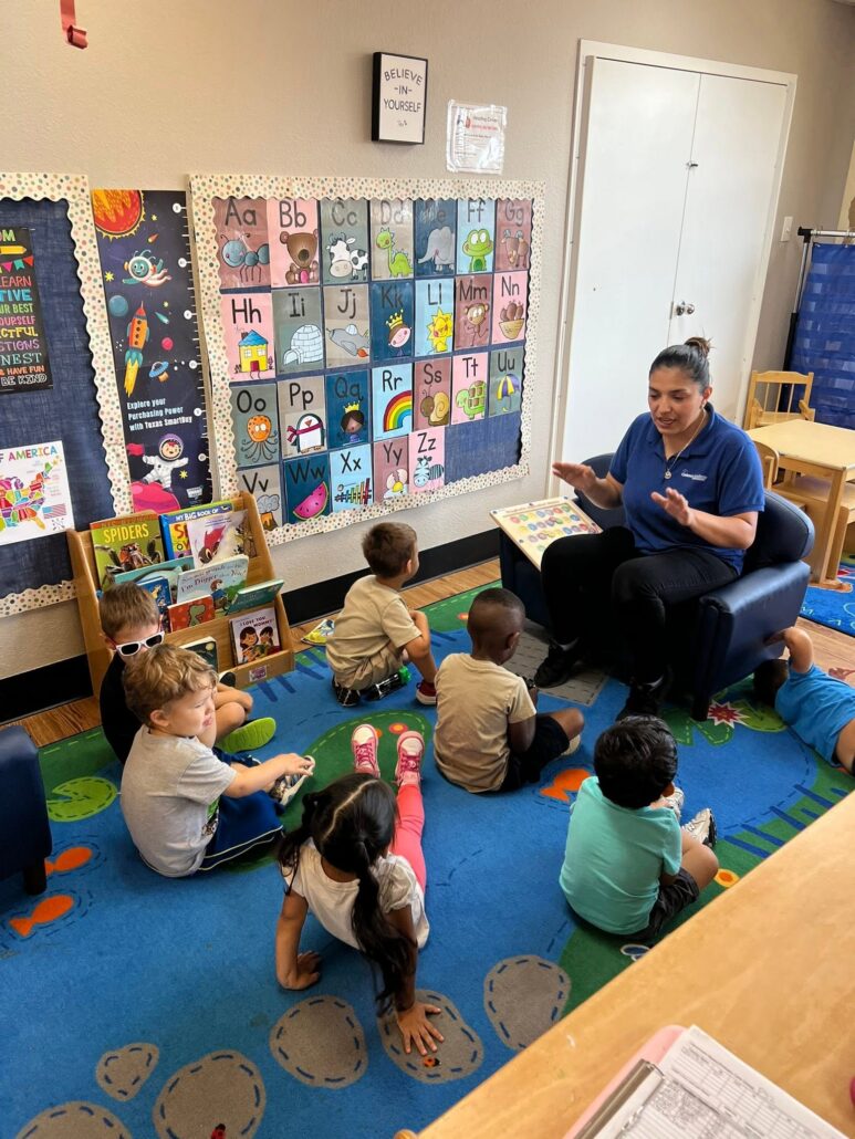 children listening to teacher read at preschool and daycare at cadence academy preschool in the colony texas