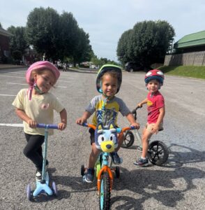 children on bikes outside together smiling at preschool and daycare cadence academy preschool 502 spring hill