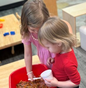 children playing in toy bin