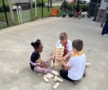 Children playing jenga together outside on the floor at Cadence academy preschool and daycare 505 murfreesboro