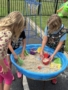 children playing outside in sand and water at preschool and daycare at cadence academy preschool smyrna, delaware