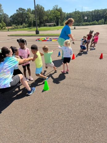 children playing tug a war outside