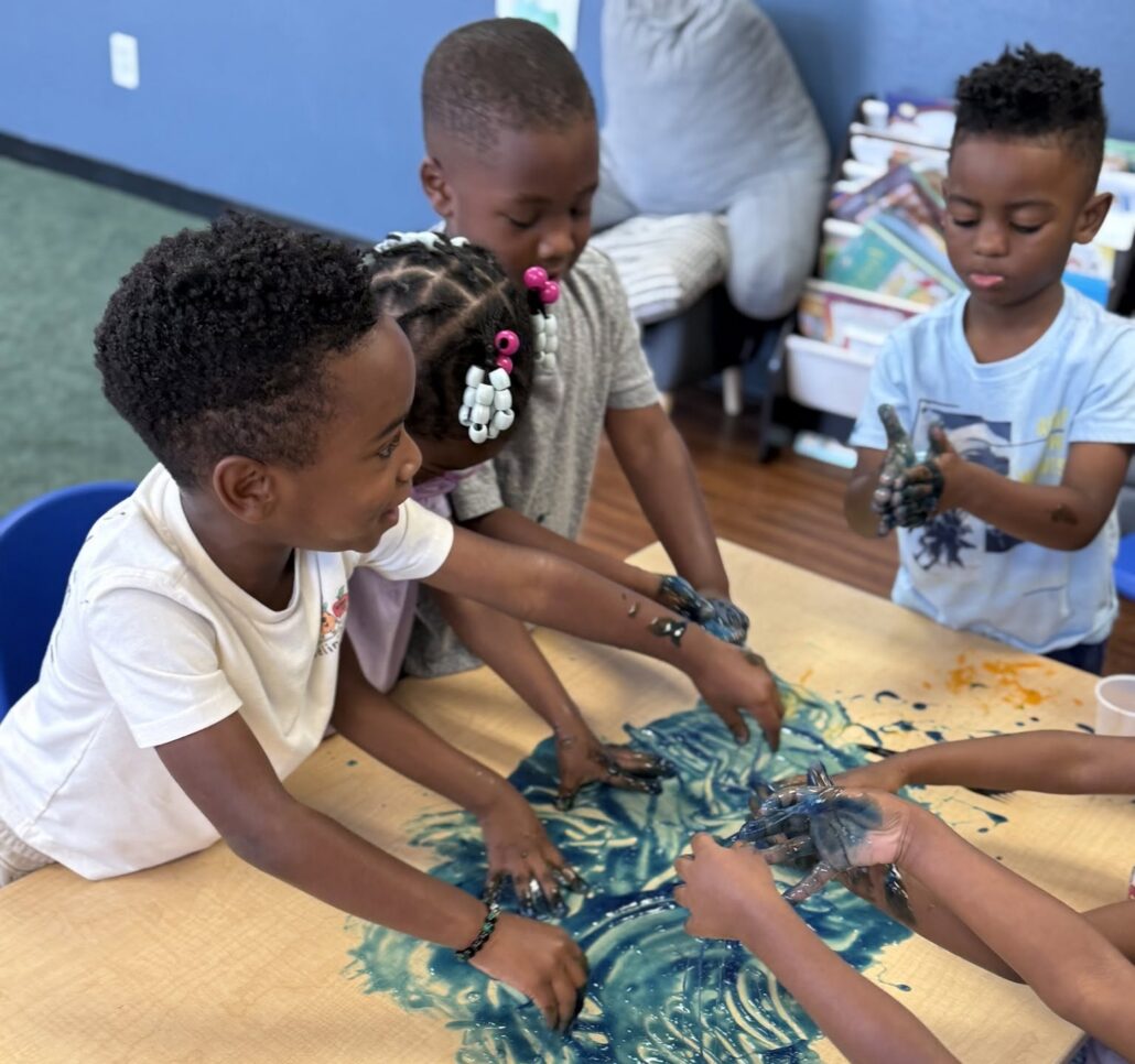 children playing with slime at cadence academy preschool at southaven