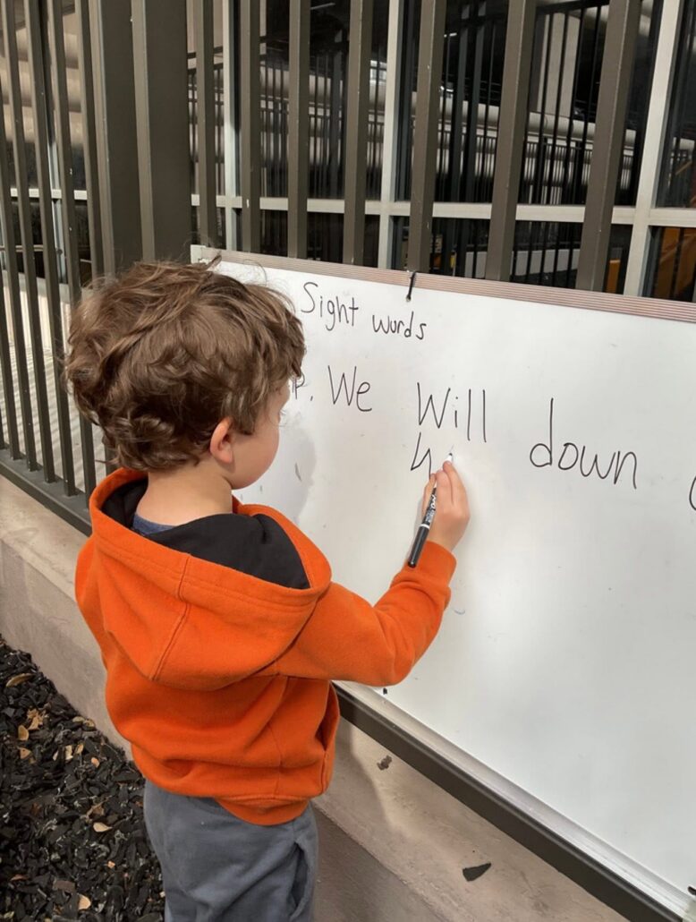 children practicing writing at preschool and daycare at cadence academy preschool galleria