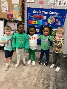 children smiling in classroom 503 cordova