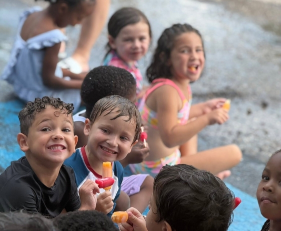 children smiling outside during water day