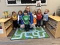 children smiling with teacher in classroom at preschool and daycare cadence academy preschool 502 spring hill
