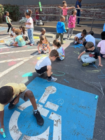 children using chalk outside
