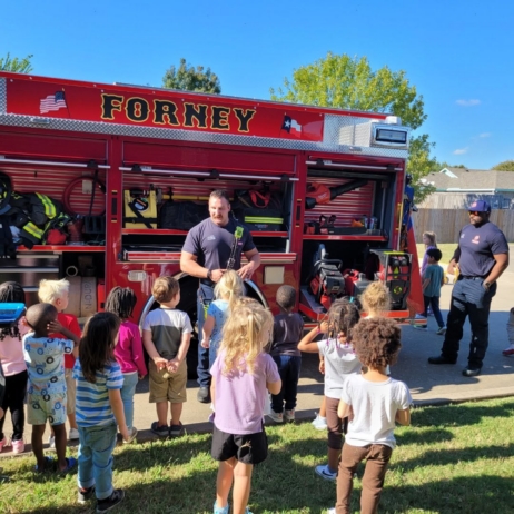 children with firefighters at preschool and daycare at cadence academy preschool forney, texas