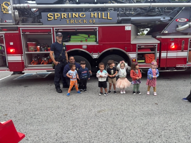 children posing with firefighters at school at preschool and daycare cadence academy preschool 502 spring hill