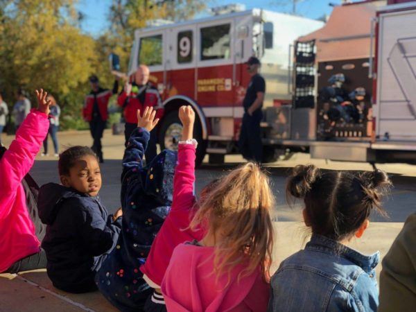 children_asking_questions_of_firefighters_at_cadence_academy_preschool_grand_prairie_tx-600x450