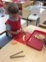 chopping_a_banana_at_smaller_scholars_montessori_academy_gilbert_az-336x450