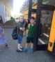 elementary_children_getting_on_bus_to_school_jonis_child_care_preschool_burlington_ct-394x450