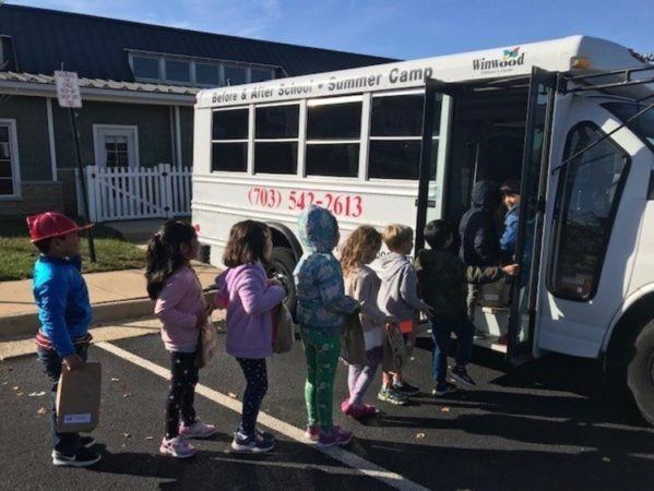 elementary_school_students_taking_bus_to_school_winwood_childrens_center_brambleton_ii_va-599x450