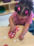 Female child engaging in a hands on activity learning at Cadence Academy Preschool Estrella Mountain