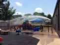 fire_department_fire_hose_cooling_off_children_on_playground_creative_expressions_learning_center_eureka_mo-603x450