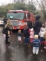 firefighter_showing_preschoolers_fire_truck_cadence_academy_preschool_clackamas_or-338x450