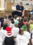 fireman_reading_book_to_class_cadence_academy_preschool_summerville_sc-328x450