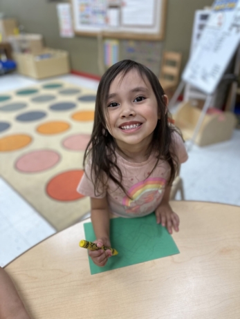 female child happy while drawing at cadence academy chandler heights