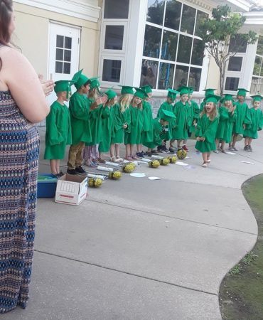 graduate_excited_to_get_her_diploma_pre-kindergarten_graduation_canterbury_preparatory_school_overland_park_ks-370x450