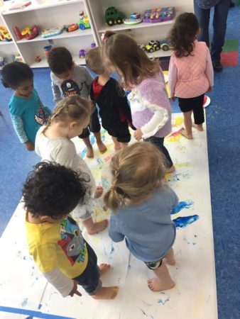 group_feet_painting_activity_creative_kids_childcare_centers_yorktown-338x450