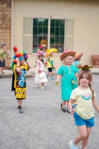 happy school age children in parade at preschool and daycare of 339 wild horse