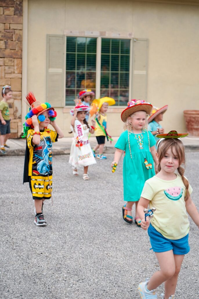 happy school age children in parade at preschool and daycare of 339 wild horse