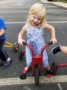 happy_preschool_girl_riding_tricycle_at_next_generation_childrens_centers_walpole_ma-336x450