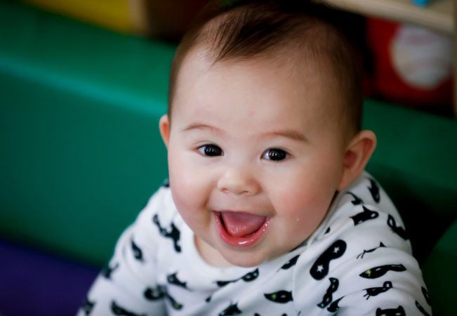 happy_toddler_smiling_into_camera_winwood_childrens_center_brambleton_va-651x450