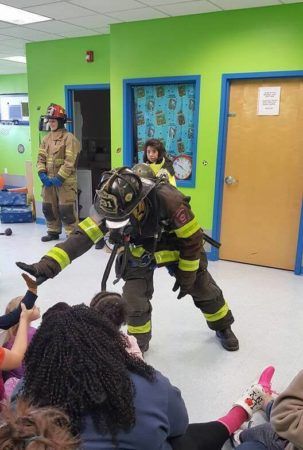 high_fiving_a_fire_fighter_prime_time_early_learning_centers_middletown_ny-303x450