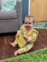 infant smiling with book in classroom at preschool and daycare cadence academy preschool nolensville 504
