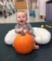 infant_boy_playing_with_pumpkin_at_next_generation_childrens_centers_franklin_ma-383x450