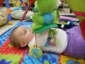 infant_enjoying_frog_and_fish_toy_cadence_academy_preschool_iowa_city_ia-600x450