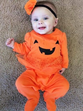 infant_girl_in_pumpkin_halloween_costume_at_cadence_academy_preschool_mauldin_sc-338x450