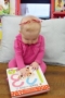 infant_girl_touching_book_at_cadence_academy_preschool_mauldin_sc-300x450