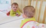 infant_smiling_into_mirror_cadence_academy_preschool_wilmington_nc-741x450