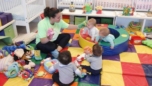 infant_teacher_playing_with_hand_puppets_prime_time_early_learning_centers_paramus_nj-752x423