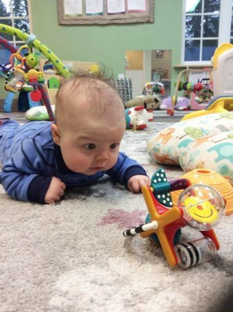 infant_tummy_time_with_toys_cadence_academy_preschool_cooper_point_olympia_wa-336x450