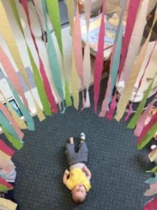 infant_under_streamers_at_next_generation_childrens_centers_andover_ma-338x450