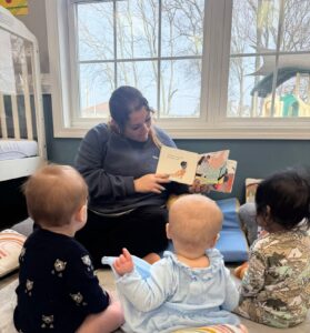 teacher reading to infants in classroom at preschool and daycare cadence academy preschool 502 spring hill