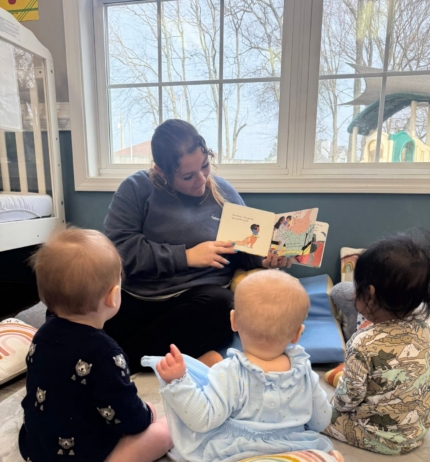 teacher reading to infants in classroom at preschool and daycare cadence academy preschool 502 spring hill