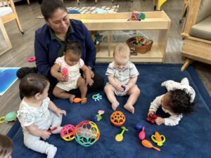 infants with teacher at preschool and daycare of 339 wild horse