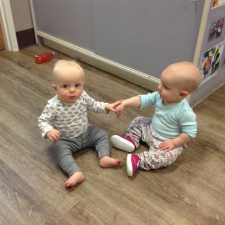 infants_holding_hands_at_cadence_academy_preschool_broomfield_co-450x450