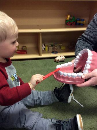 learning_to_brush_teeth_cadence_academy_preschool_grand_west_des_moines_ia-336x450
