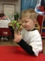 looking_at_branch_through_magnifying_glass_at_cadence_academy_preschool_broomfield_co-336x450