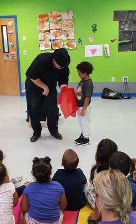 magician_performing_scarf_trick_prime_time_early_learning_centers_middletown_ny-273x450