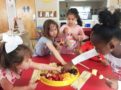 making_fruit_kebobs_cadence_academy_preschool_surfside_myrtle_beach_sc-603x450