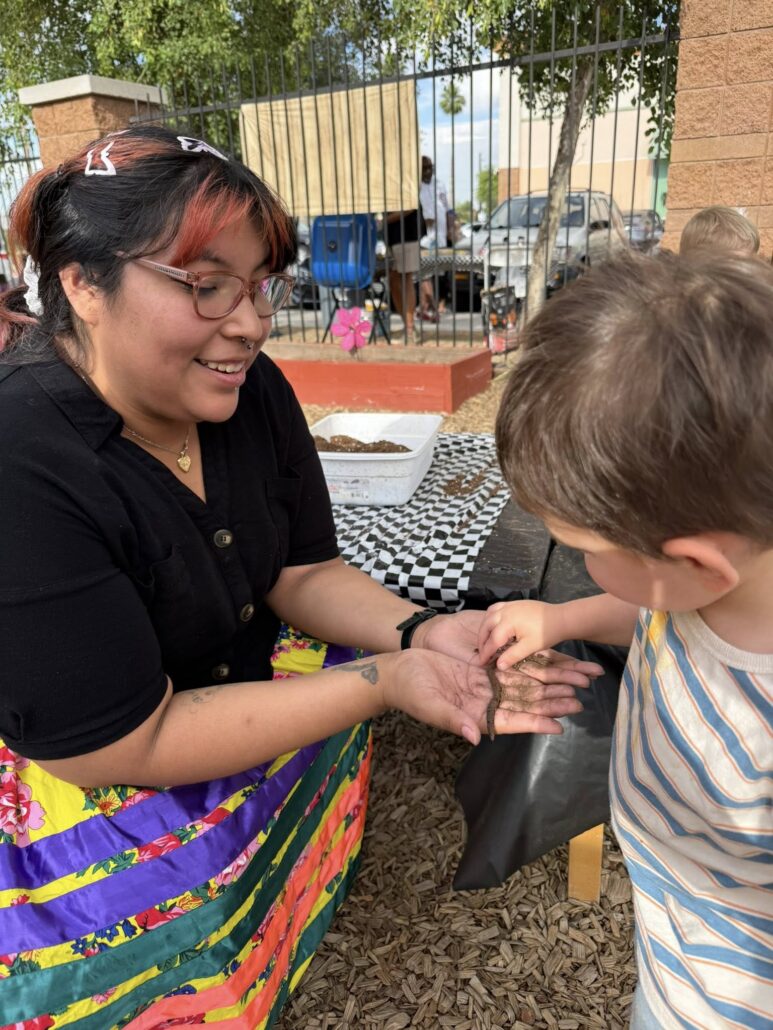 Male child interacting with teacher while exploring outdoors at cadence academy preschool gilbert